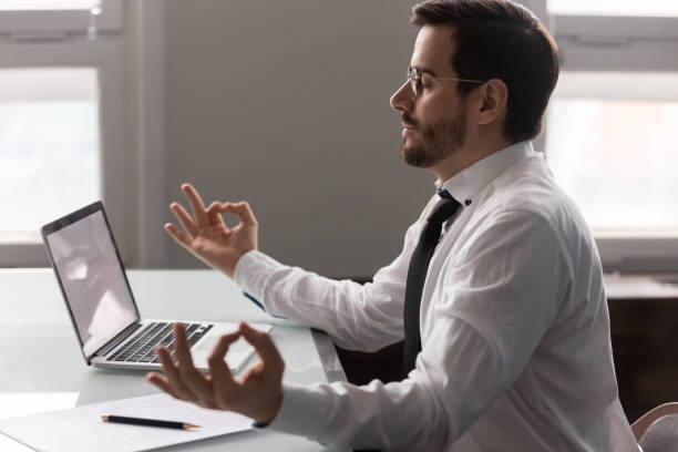 istock Businessman practices of concentration meditation seated at workplace 1252926511