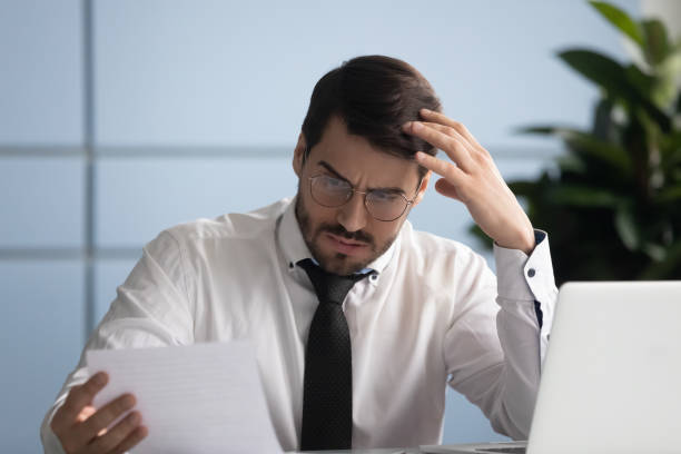 istock Concerned business owner reading letter from bank about financial problems 1252926518