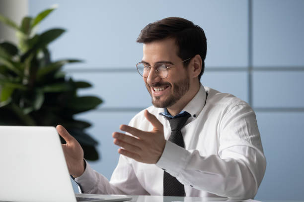 istock Cheery businessman looking at laptop screen makes videocall enjoy talk 1252926521