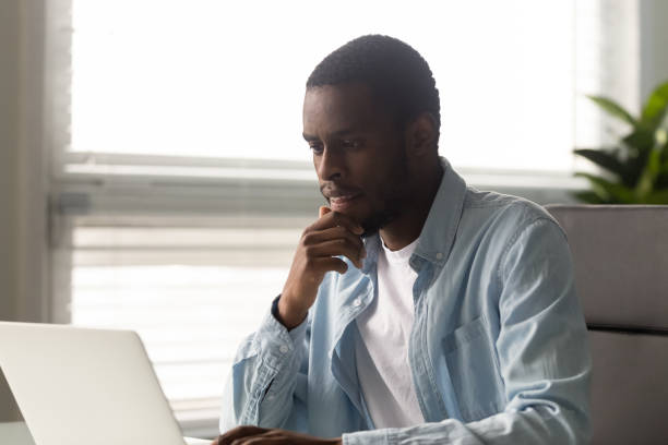 istock Serious American worker thinks over business email working on laptop 1252926531