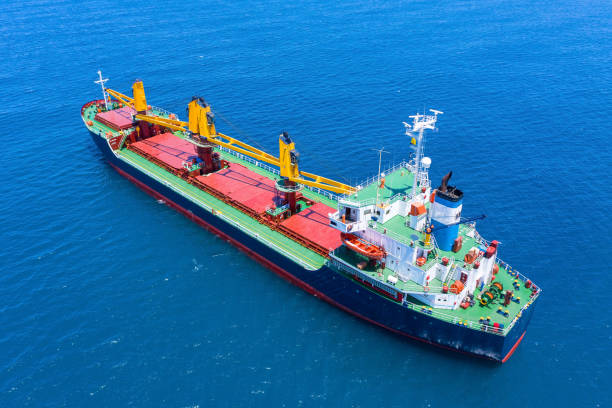 istock Large Cargo Ship with four Yellow cranes at sea. 1252927415