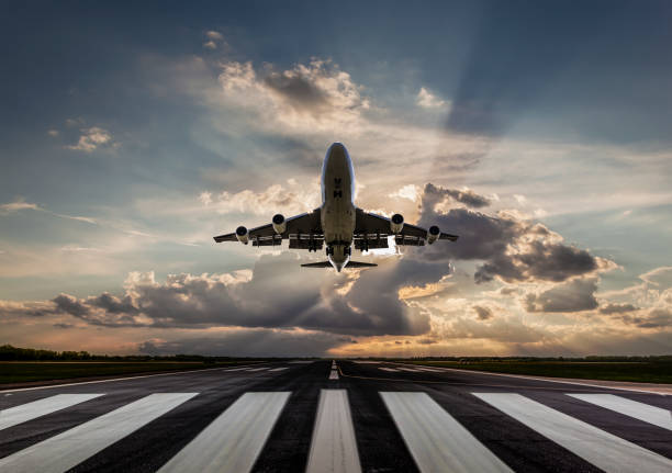 istock Passenger airplane taking off at sunset 1252929747