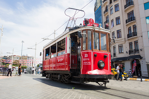 Unidentified people by Istanbul nostalgic tramways in Istanbul, Turkey. In Istanbul there are are two tramlines with heritage streetcars.