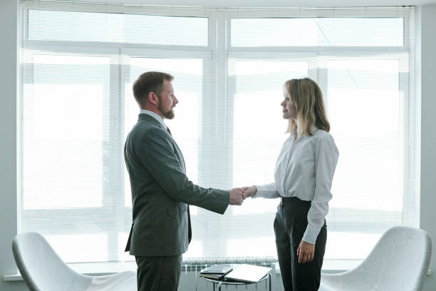 istock Confident hr manager shaking hand of young successful applicant after interview 1252937436