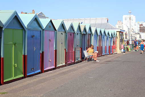 Brighton, England -June 25, 2020: Crowds at Brighton beach amid pandemic. Despite lockdown restrictions due to the Coronavirus, crowds gather on the sandy beach on the hottest day of the year.