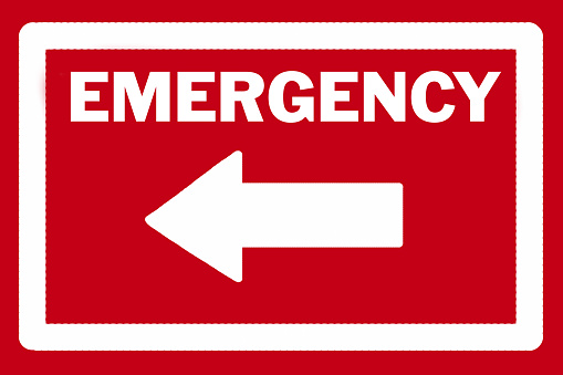 EMERGENCY sign and arrow in white pointing to the left against a red background.