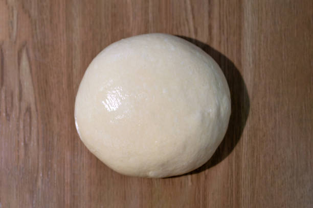 istock Fresh ball of dough on a wooden table. 1252943783