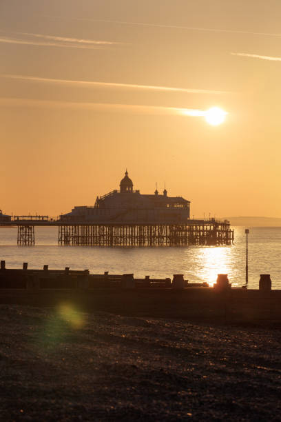 beau lever de soleil au-dessus de l’horizon de manche et de jetée d’eastbourne, east sussex, royaume-uni - horizon over water england uk summer photos et images de collection