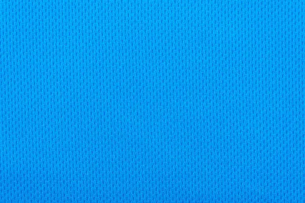 Photo of Smooth surface of a blue polyester sport t-shirt as background or texture