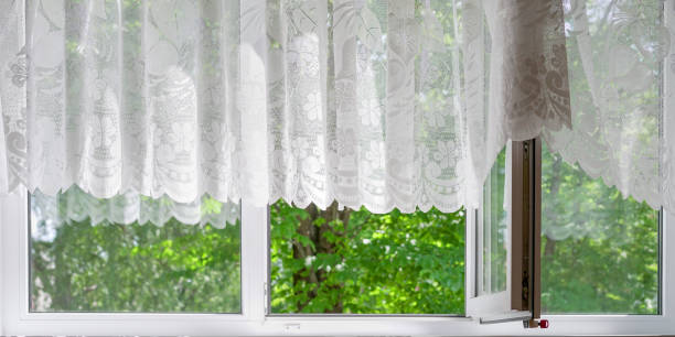istock light breeze blowing white transparent fabric curtain through white open large window plastic frame 1252944822