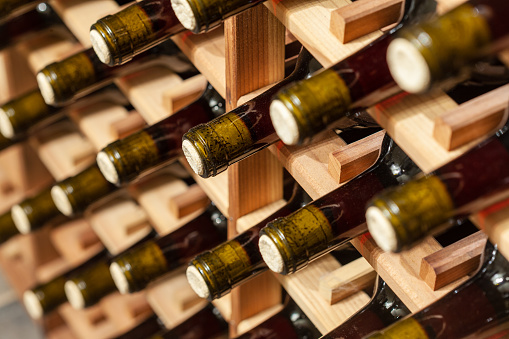 Moscow, Russia - January 6, 2020: Department of alcoholic beverages in a supermarket, shelves with glass bottles of red and white grape wine from different countries. Great wine selection