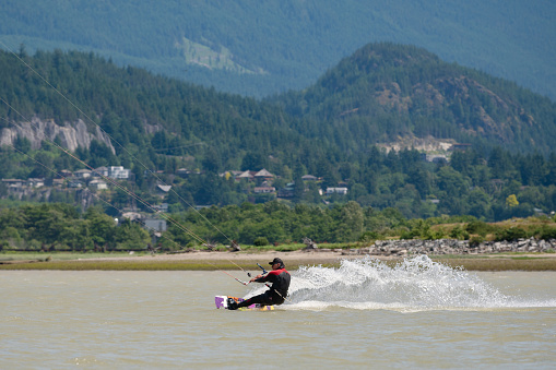 Kiteboarding in Squamish, British Columbia. Active male enjoying water sports. Adventure on the sea.