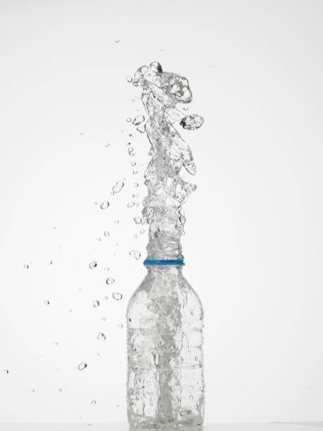 istock Water in glass bottle splashing 1252946562