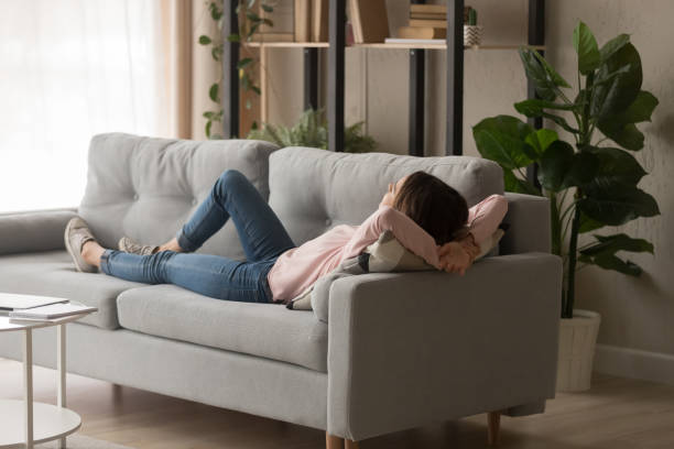 istock Millennial lady sleeping on comfy sofa at home. 1252949326