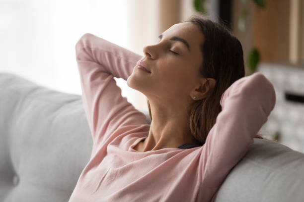 istock Young serene relaxing woman face close up side view. 1252949333