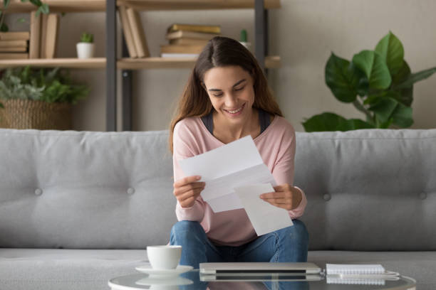 istock Happy smiling millennial girl holding paper document. 1252949353