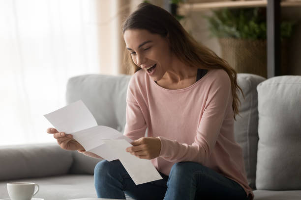 istock Happy surprised millennial lady reading last payment bank loan document. 1252949360