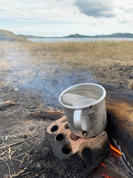istock A mug of boiling water is prepared on a fire against a blue sky 1252949532