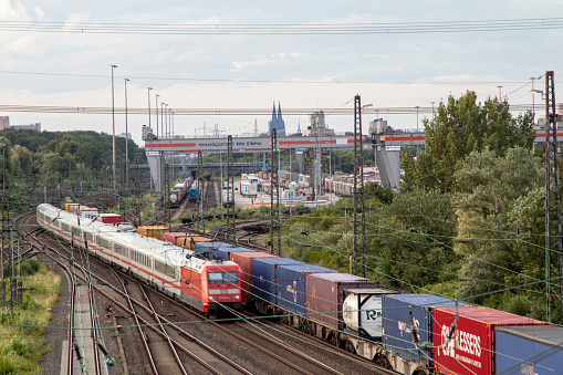 Huerth, NRW, Germany, 06 27 2020, cargo train before skyline of cologne, container station cologne Eifeltor, passenger train, outdoor