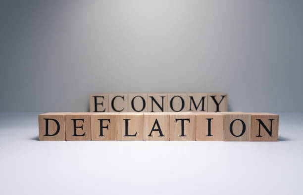 istock Deflation text from wooden cubes. Spot light in the studio and white background. 1252957507