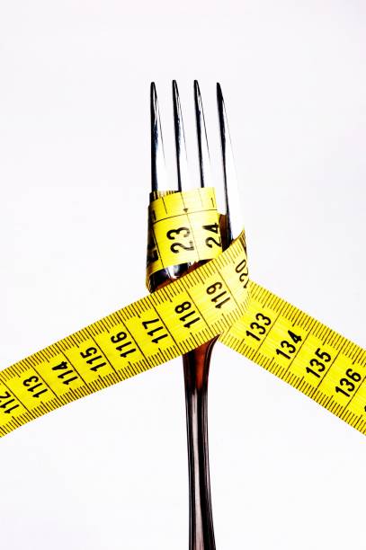 istock Measuring Tape and Fork, Close Up 1252960322
