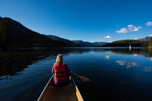 istock Woman canoeing on a mountain lake 1252960476