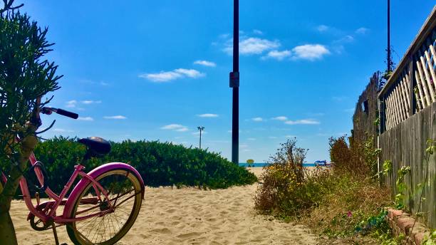 istock pink bike on the sand 1252961985