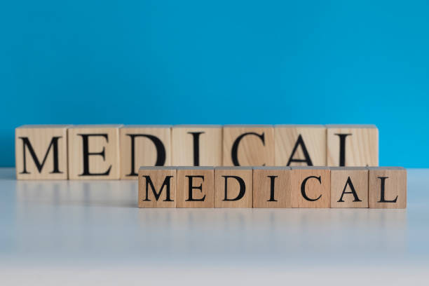 istock Medical text from wooden cubes. White backdrop blue background. Studio 1252963926