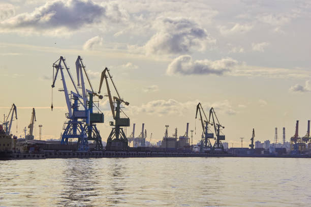 istock cargo crane for loading raw materials on sea vessels 1252965523
