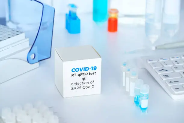 Photo of Quick novel COVID-19 coronavirus test kit. 2019 nCoV pcr diagnostics kit. Hand in glove with the box. The kit detects covid19 virus. Тest system for real-time quantitative PCR amplification.