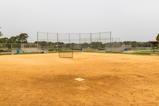 View from behind second base on an empty baseball field in a suburban Florida park.