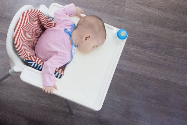 istock Cute baby in rose jacket fell asleep while feeding 1252969621