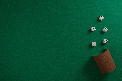 Dice and dice cup on a green cloth. 3d illustration.