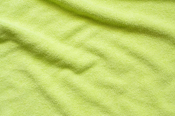 istock Green towel fabric texture surface close up background 1252975374