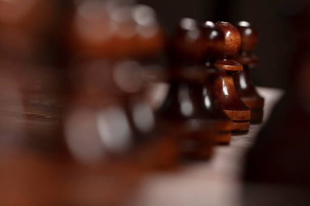 Chess pawns standing in a row