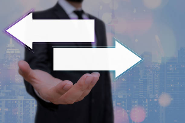 istock A An Individualin Doubt, Having To Choose Between Two Choices Indicated By Arrows Pointing In Opposite Direction Concept. Rivalry Metaphor Competitiveness Symbol In Diverging Views. 1252975910
