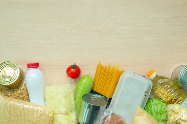 istock Food donations on wood table. top view 1252979143