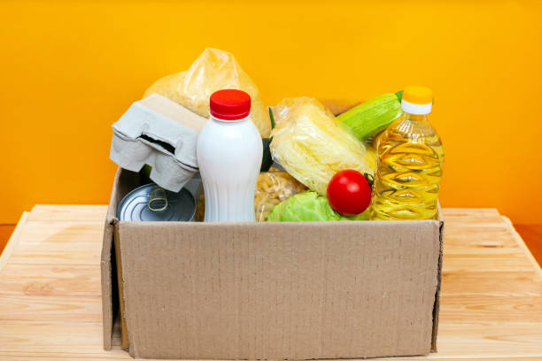 istock Various canned food, eggs and vegetables in a cardboard box. 1252979144