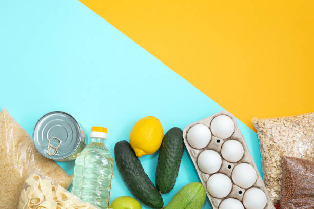 istock Food donations on yellow background, top view 1252979147