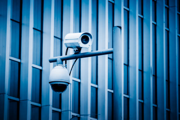 istock close-up view of security camera, in front of office building 1252984770