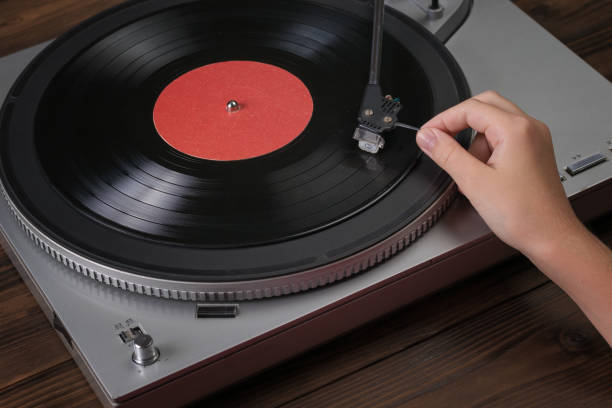 istock The hand puts the needle down on the vinyl record. 1252992773