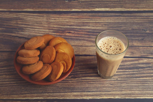 istock Cup of Tea on wooden table with Butter biscuits 1253001673