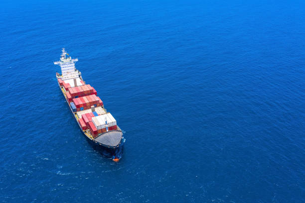 istock Large loaded container Ship cruising slowly at Sea. 1253002530