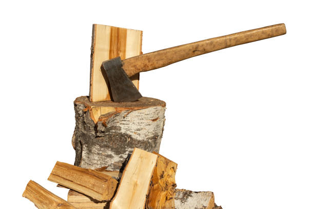 istock Cleaved birch firewood and an ax in a birch chopping block isolated on a white background. 1253003378