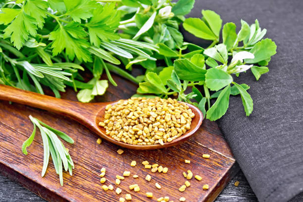 istock Fenugreek in spoon with herbs on black board 1253003411