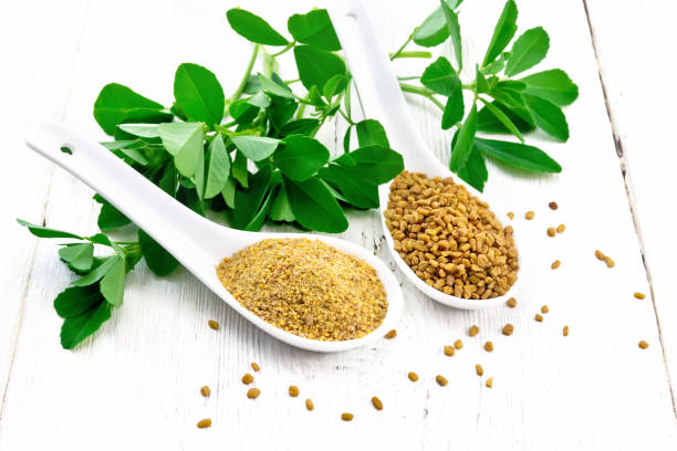 istock Fenugreek in two spoons with leaves on board 1253003412