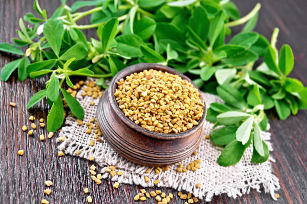 istock Fenugreek in bowl with leaves on dark board 1253003413