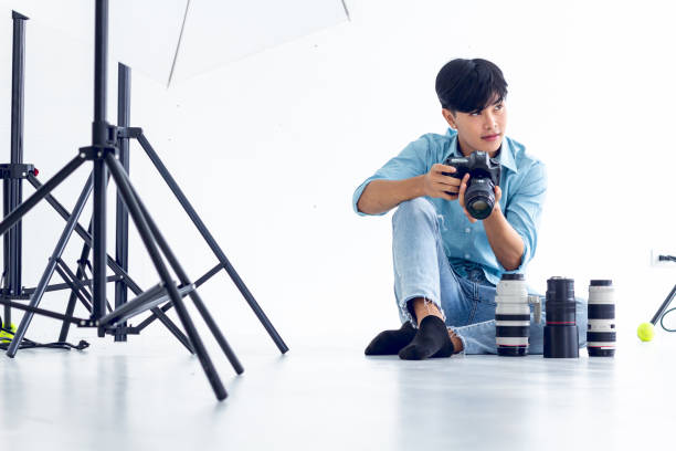 istock young photographer is taking pictures in the studio with a digital camera. 1253004841