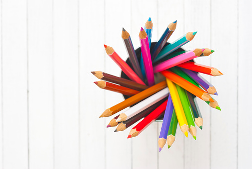 color pencils in tincan, wood table