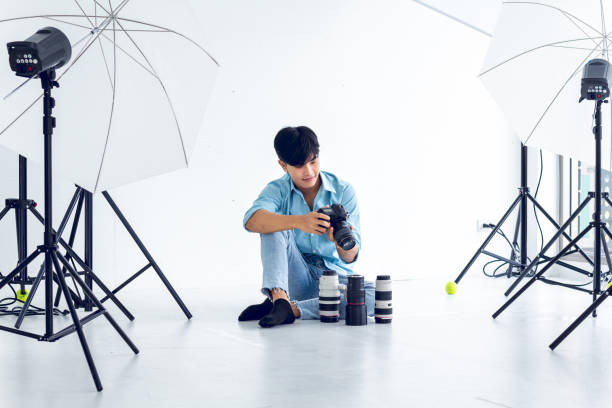 istock young photographer is taking pictures in the studio with a digital camera. 1253005905